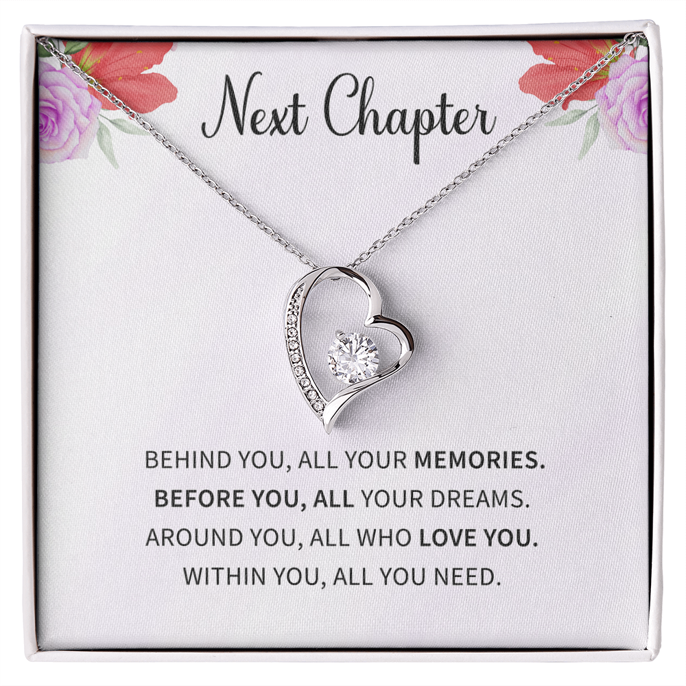 Silver open heart pendant necklace with a center stone, gifted with a "New Chapter" message.

