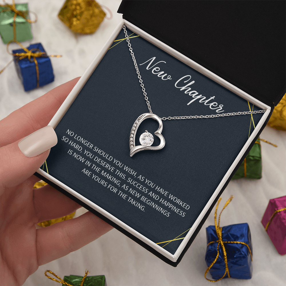 Silver open heart pendant necklace with a center stone, gifted with a "New Chapter" message.
