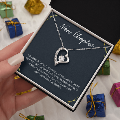 Silver open heart pendant necklace with a center stone, gifted with a "New Chapter" message.