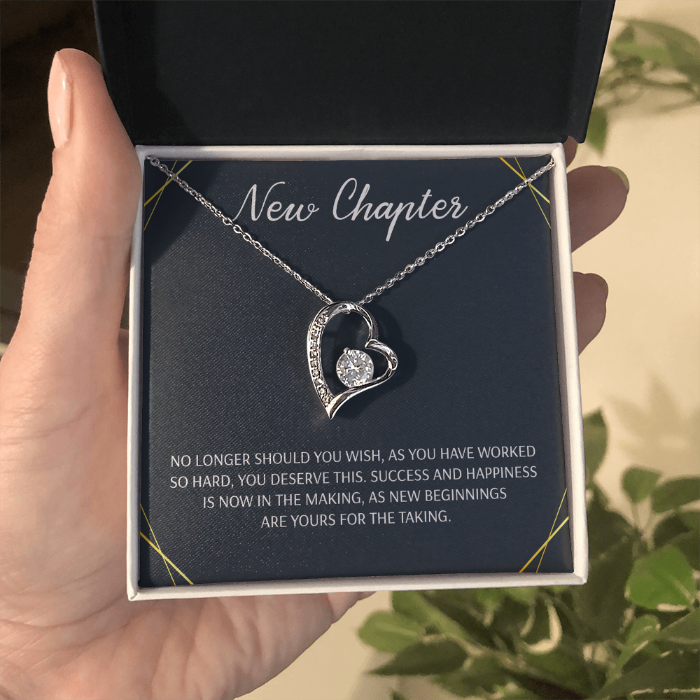 Silver open heart pendant necklace with a center stone, gifted with a "New Chapter" message.

