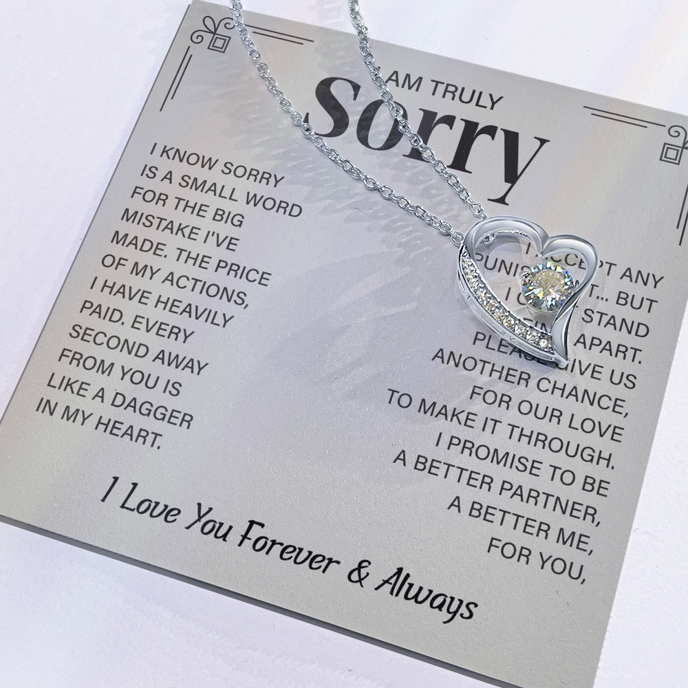 Sorry necklace in heart-shaped box.