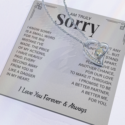 Sorry necklace in heart-shaped box.