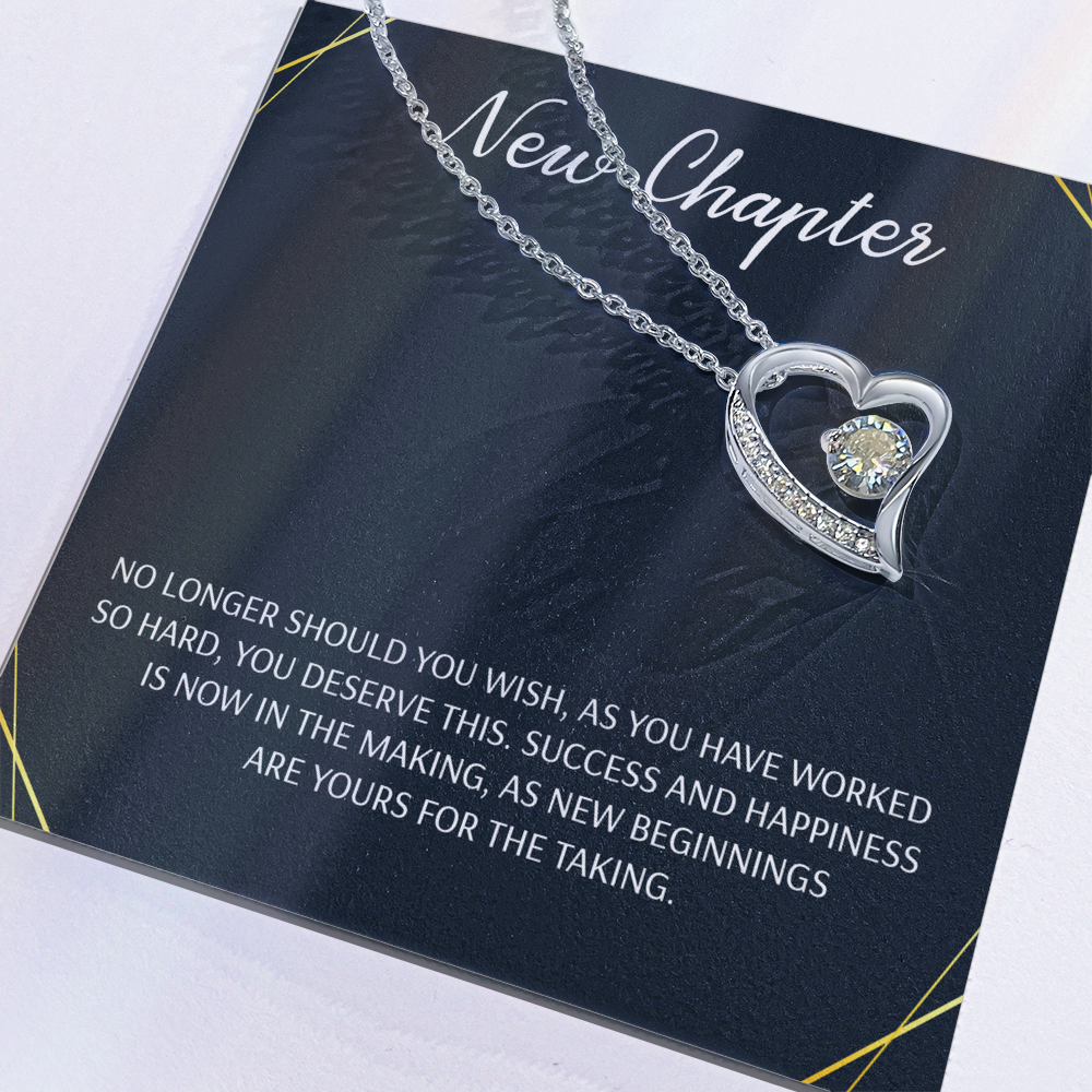 Silver open heart pendant necklace with a center stone, gifted with a "New Chapter" message
