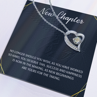 Silver open heart pendant necklace with a center stone, gifted with a "New Chapter" message
