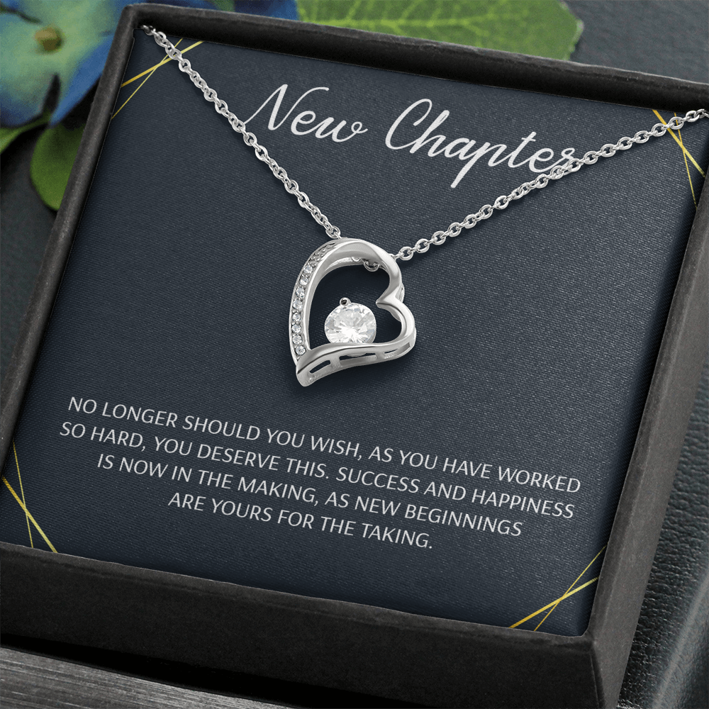 Silver open heart pendant necklace with a center stone, gifted with a "New Chapter" message.


