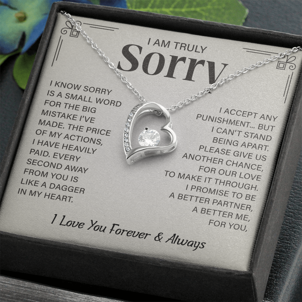 Sorry necklace in heart-shaped box.