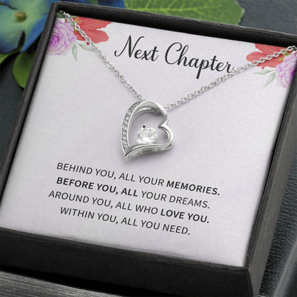 Silver open heart pendant necklace with a center stone, gifted with a "New Chapter" message.

