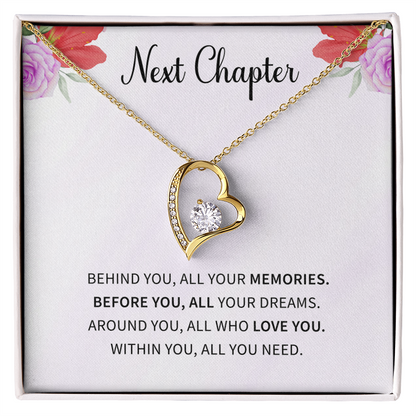 Silver open heart pendant necklace with a center stone, gifted with a "New Chapter" message.

