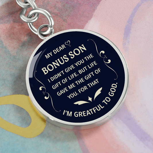 "Bonus Son" keychain in a deep blue and white design.

