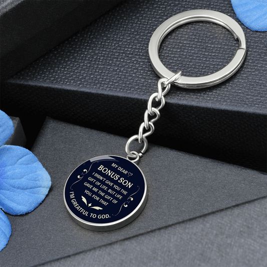 "Bonus Son" keychain in a deep blue and white design.

