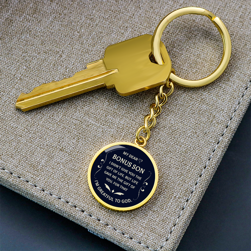 "Bonus Son" keychain in a deep blue and white design.

